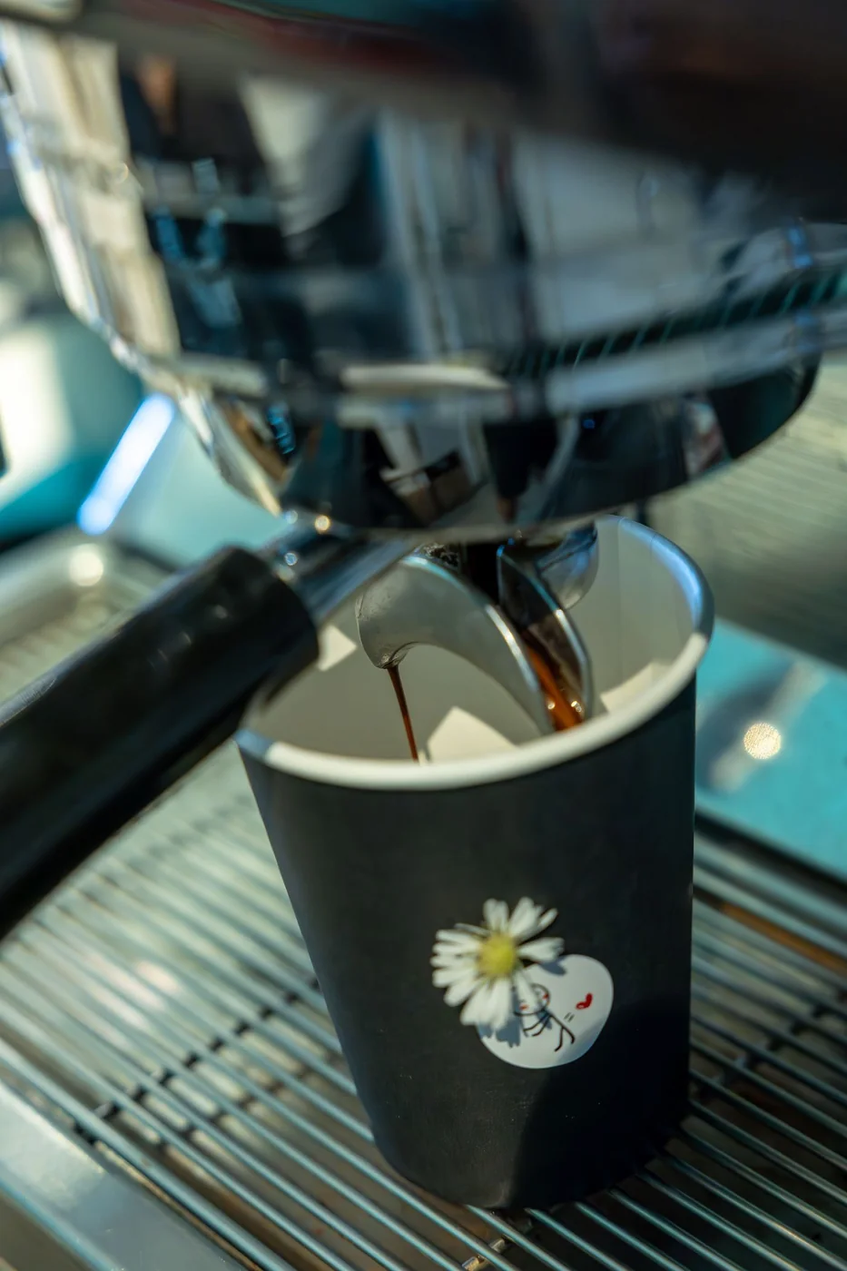 Espresso brewing into a cup from a professional espresso machine